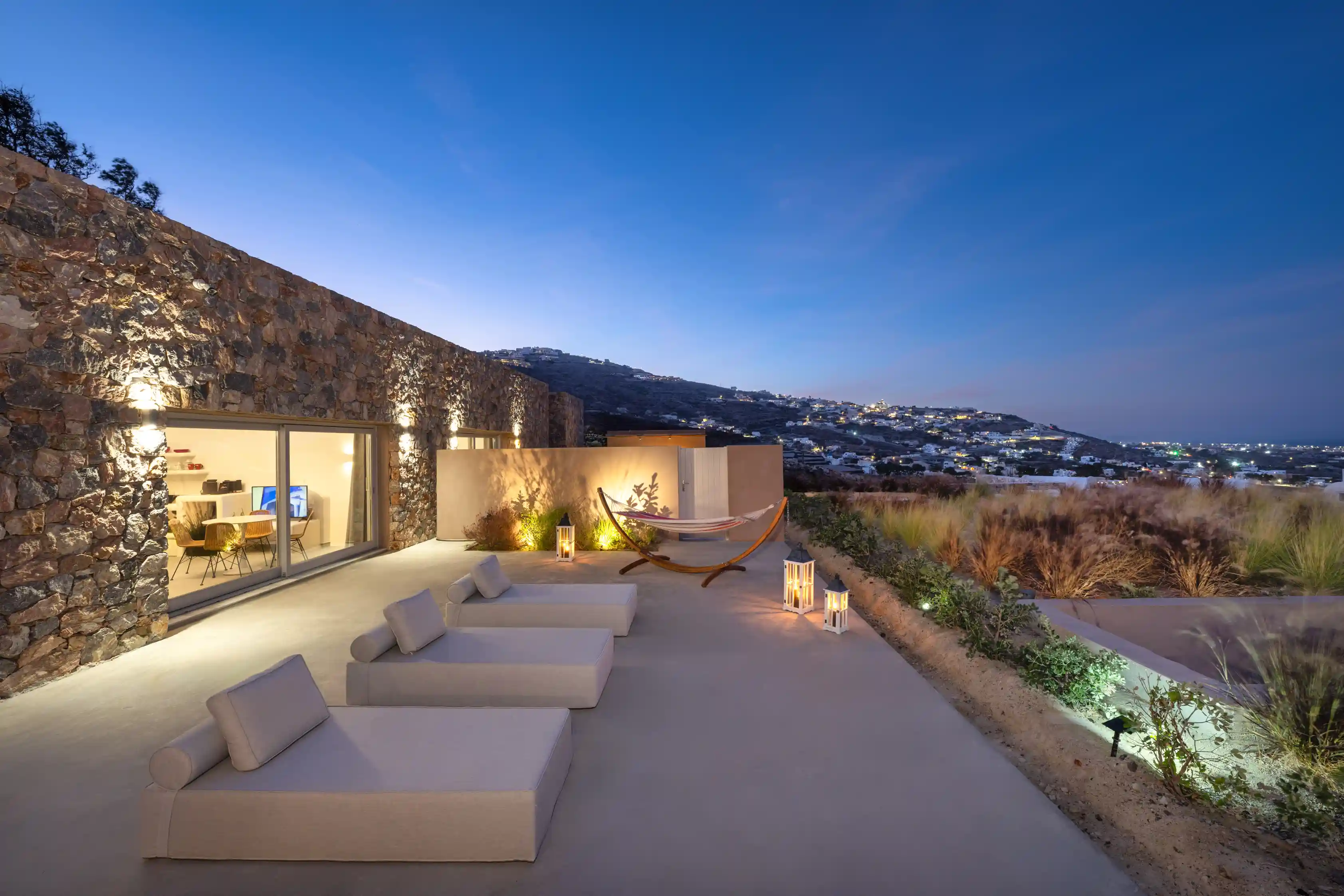 Deluxe Gaia Cave Villa private patio at night - Romantic evening atmosphere with ambient lighting