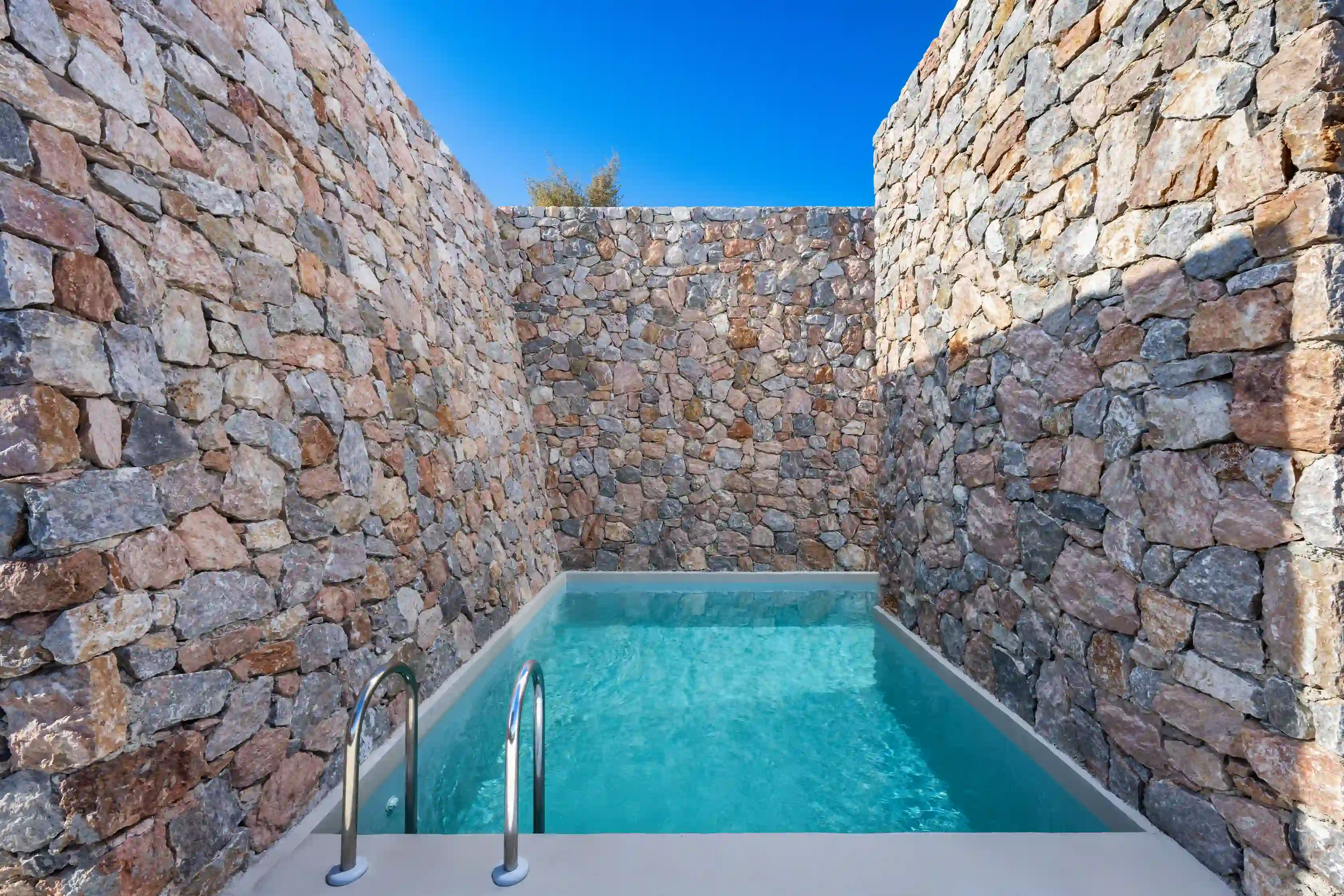 Deluxe Gaia Cave Villa stone exterior with private swimming pool - Traditional Cycladic architecture