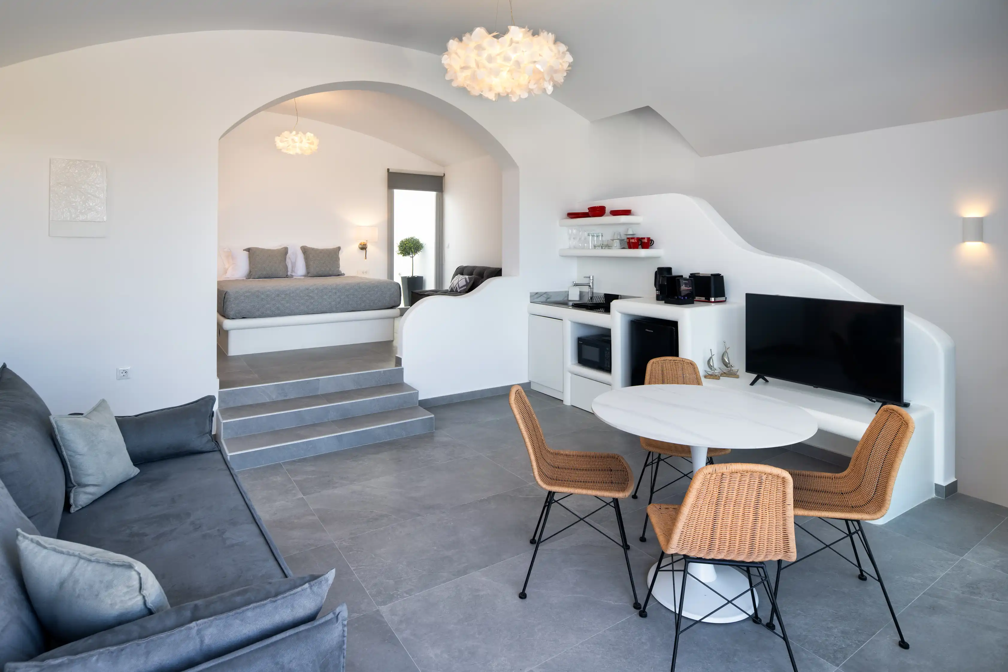 Deluxe Gaia Cave Villa interior living and dining area - Open plan design with stone architecture