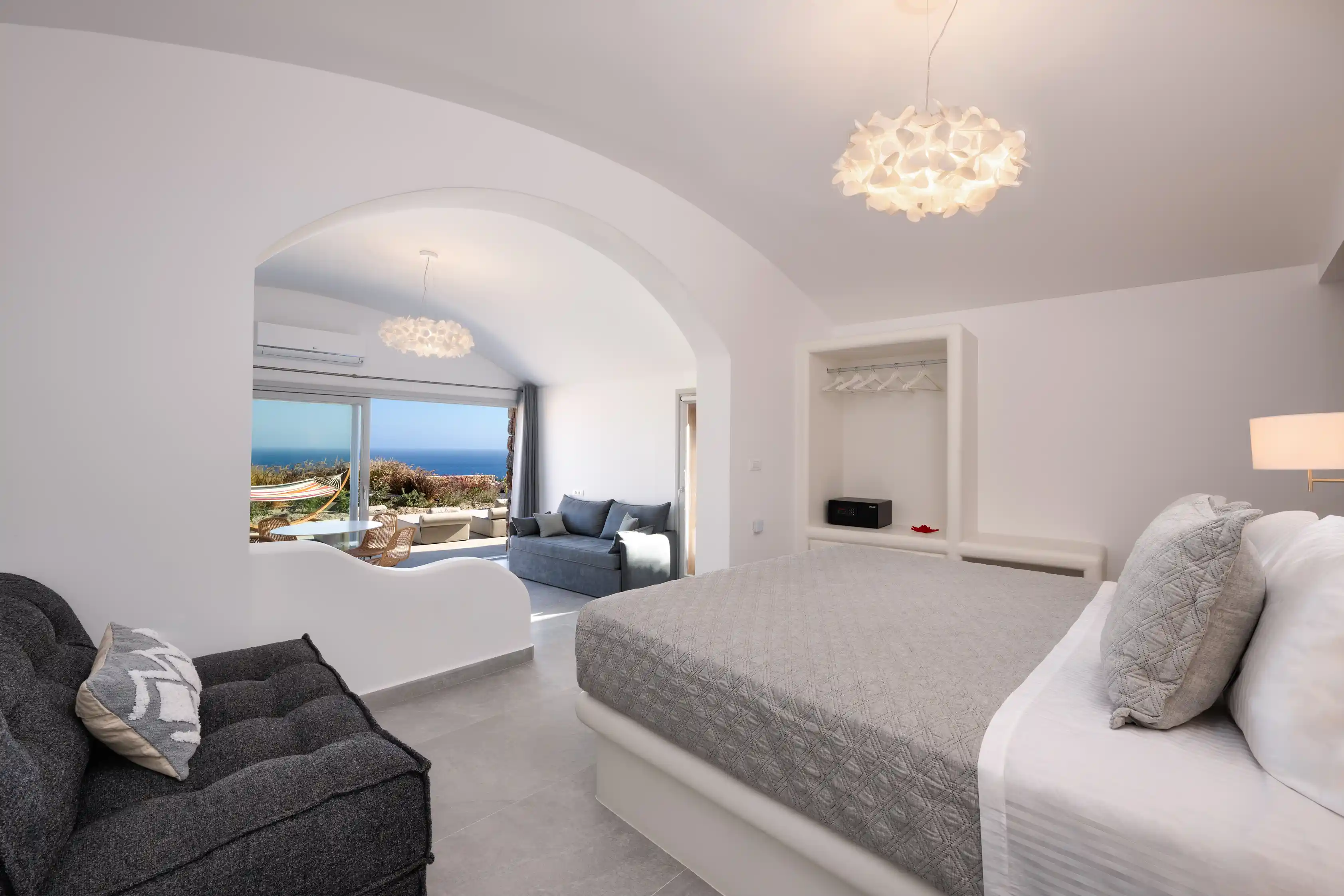Deluxe Gaia Cave Villa bedroom with sea view - King-size bed with panoramic Aegean Sea vistas