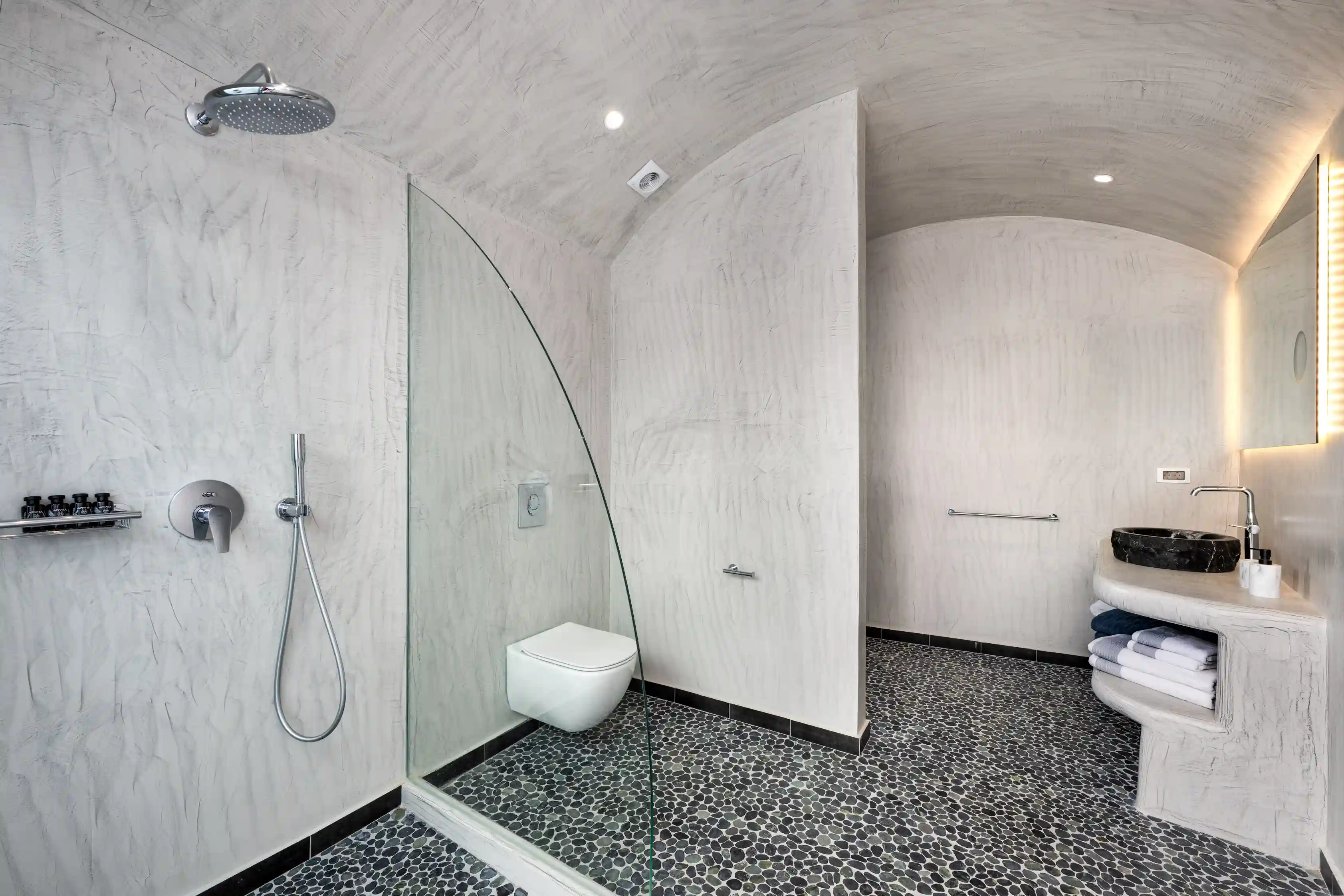 Deluxe Gaia Cave Villa bathroom with stone sink - Traditional Cycladic design with modern amenities